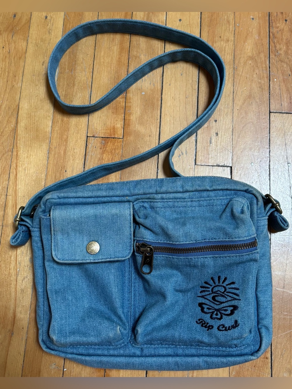 Rip Curl denim crossbody utility bag.